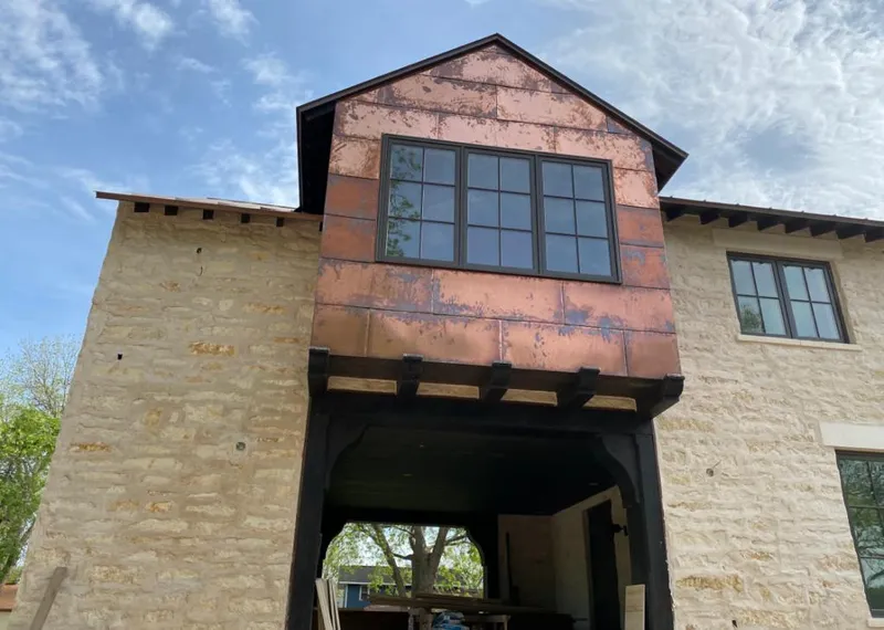Copper metal panel facade on a stone building for Metal Roof Coating in Allouez
