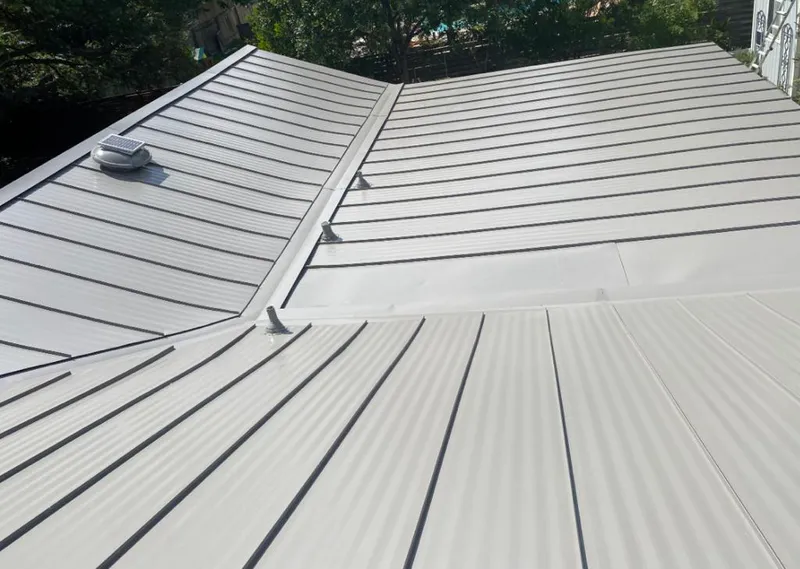 Solar attic fan installed on a metal roof for Roof Ventilation in Allouez